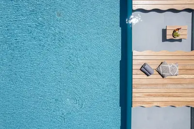two views of a pool of water with two rocks at Magical new luxury villa Camellia! in Kissamos
