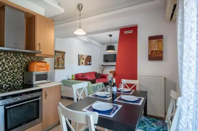 a kitchen and living room with a table and chairs at Souda Bay View with Private Pool near Chania City in Chania Town