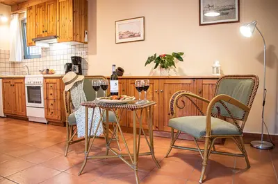 a kitchen with a table with glasses of wine at glarosmaisonette in Kato Daratso