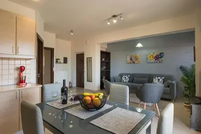 a kitchen and living room with a table with a bowl of fruit at Casa Del Sol-Halepa- in Chania Town