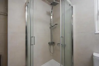 a shower with a glass door in a bathroom at Casa Del Sol-Halepa- in Chania Town