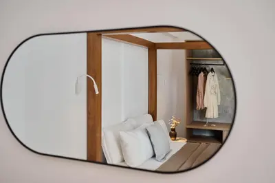 a mirror reflection of a white chair in a dressing room at Kyamon Luxury Villa with Heated Saltwater Pool Near Chania in Chania Town