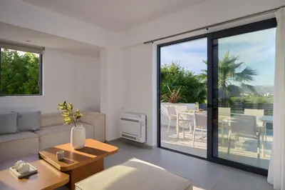 a living room with a couch and a table at Kyamon Luxury Villa with Heated Saltwater Pool Near Chania in Chania Town