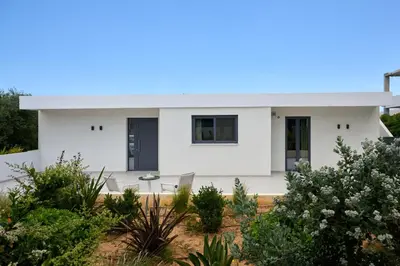a white house with a lot of plants at Kyamon Luxury Villa with Heated Saltwater Pool Near Chania in Chania Town