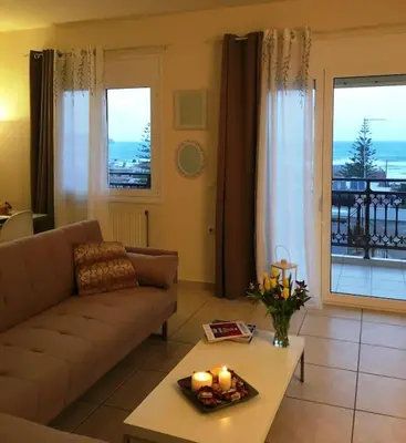 a living room with a couch and a table with candles at Sea View Apartment #2 in Stalos