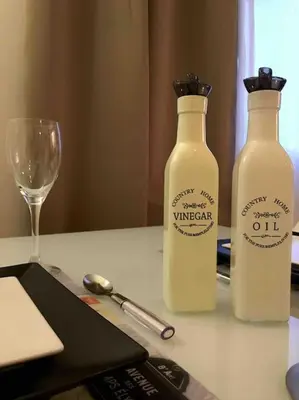 two bottles of milk sitting on a table with a glass at Sea View Apartment #2 in Stalos