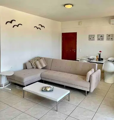 a living room with a couch and bats on the wall at Sea View Apartment #2 in Stalos