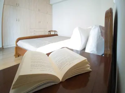 an open book sitting on a desk with a bed at Kadiani's Residence by 8essentially in Chania Town