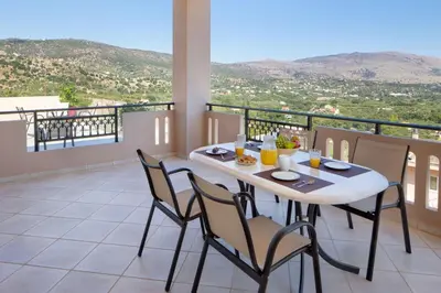 a table and chairs on a balcony with a view at Iconic Villa with private pool and sea view in Próvarma