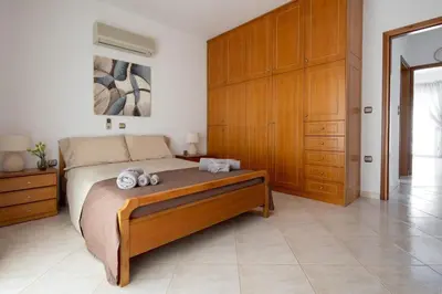 a bedroom with a bed with two towels on it at Iconic Villa with private pool and sea view in Próvarma