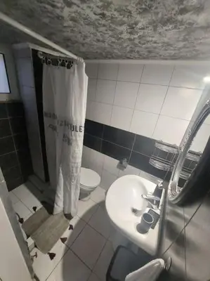 a bathroom with a sink and a shower and a toilet at Koum Kapi 1st floor apt in Chania Town