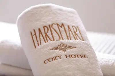 a white towel with the name harringtonoclly hotel on it at Harismari Cozy Hotel in Chania Town