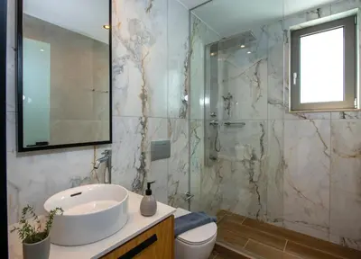 a bathroom with a sink and a glass shower at Villa Manu Luxury Living in Stalos