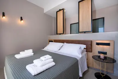 a bedroom with a bed with towels on it at Villa Manu Luxury Living in Stalos