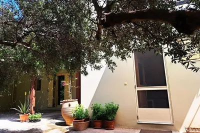 a house with potted plants in front of it at Mavrogenis Farm Chania Crete in Plataniás