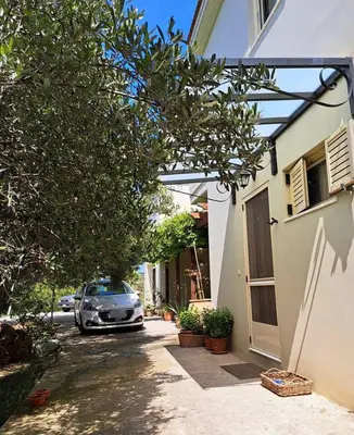 a car parked in the driveway of a house at Mavrogenis Farm Chania Crete in Plataniás
