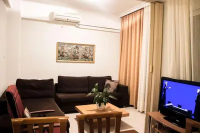 a living room with a couch and a tv at Nelly's House in Chania Town