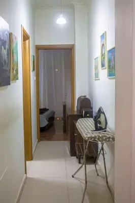 a room with a hallway with a table and a chair at Nelly's House in Chania Town