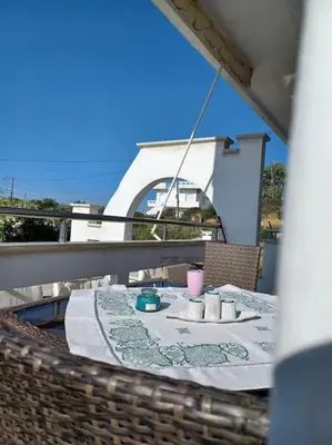 a table on a balcony with a drink on it at Casa Dastele remarkable seaview 5' from the sea in Chania Town