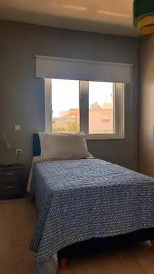a bedroom with a bed and a window at Elena Apartments in Kato Daratso