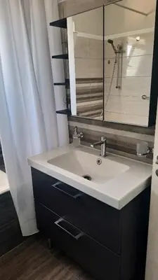 a bathroom with a white sink and a mirror at Elena Apartments in Kato Daratso