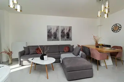 a living room with a couch and a table at Elia Beach Deluxe Apartment in Chania Town