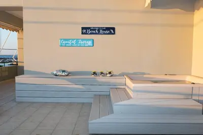 two benches in a room with a sign on a wall at Elia Beach Deluxe Apartment in Chania Town
