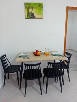 a table and chairs with a bowl of fruit on it at Casa Artemis in Plátanos