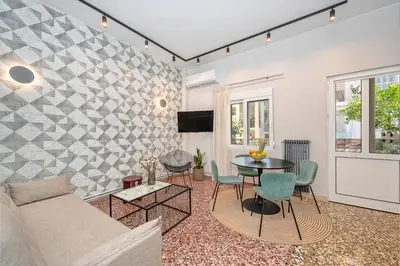 a living room with a couch and a table at JasmineStay - Two bedroom apartments with backyard in Chania Town