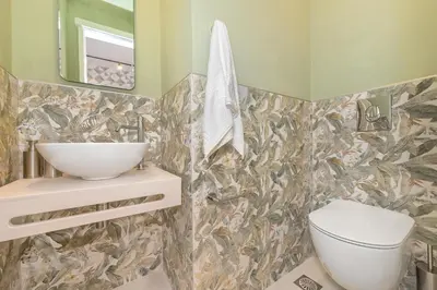 a bathroom with a sink and a toilet at JasmineStay - Two bedroom apartments with backyard in Chania Town