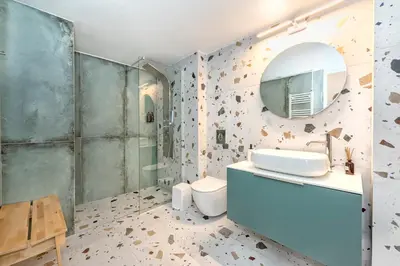 a bathroom with a sink and a toilet and a mirror at JasmineStay - Two bedroom apartments with backyard in Chania Town