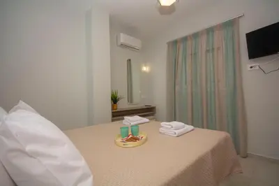 a room with a table with towels and a mirror at Korfali Apartments in Kissamos