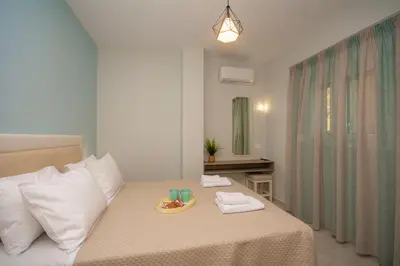 a bedroom with a bed with a tray of food on it at Korfali Apartments in Kissamos