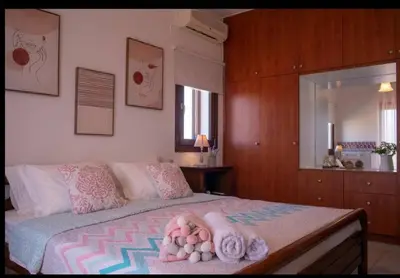 a bedroom with a bed with towels on it at Al Aker Villa with private pool in Kalathas
