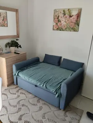a bed in a room with a blue bed frame at Ethereum City Αpartment - Suite in Chania Town