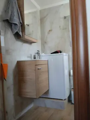 a bathroom with a sink and a refrigerator at Ethereum City Αpartment - Suite in Chania Town