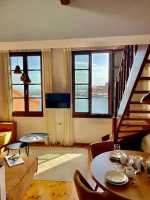 a living room with a staircase and a table and chairs at Erietta Suites in Chania Town