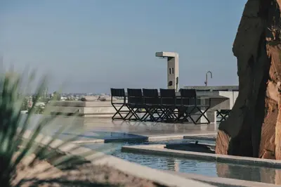 a pool with a bench and a table on a building at Inspiration House in Souda