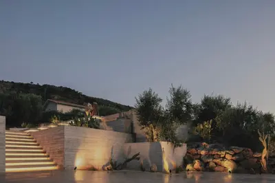 a resort with stairs and trees and a river at Inspiration House in Souda