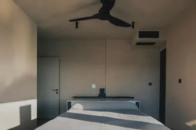 a bedroom with a bed with a ceiling fan at Inspiration House in Souda