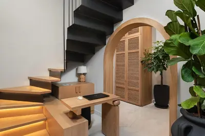a living room with a table and a stairway at The Alma City Suites in Chania Town