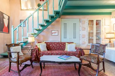 a living room with a couch and a staircase at Thimari Gardens in Chania Town