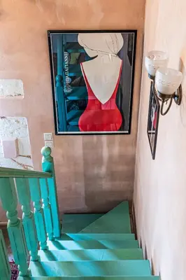 a painting of a woman in a red dress on a staircase at Thimari Gardens in Chania Town