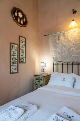 a bedroom with a bed with two towels on it at Thimari Gardens in Chania Town