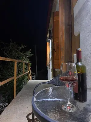 a bottle of wine and a glass on a table at Villa Nama in Kissamos