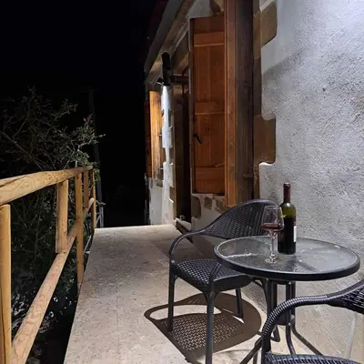 a table with two chairs and a bottle of wine at Villa Nama in Kissamos
