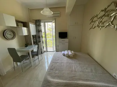 a bedroom with a bed and a table and a desk at Anastasia City Home in Chania Town