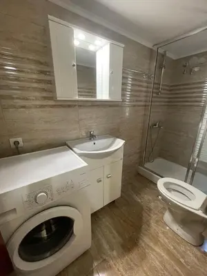 a bathroom with a washing machine and a sink and a toilet at Anastasia City Home in Chania Town