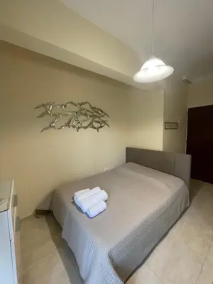 a bedroom with a bed with two towels on it at Anastasia City Home in Chania Town