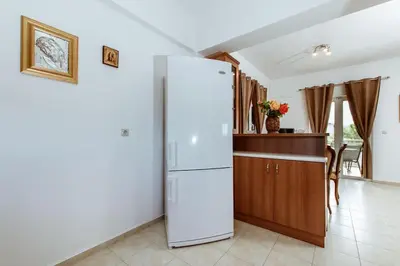 a kitchen with a white refrigerator in a room at Suite Erato in Kissamos